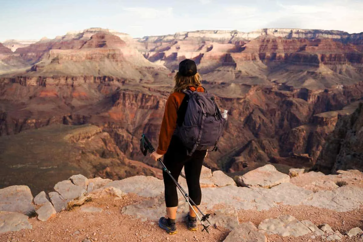 Female hiker looking over the rim of the Grand Canyon.