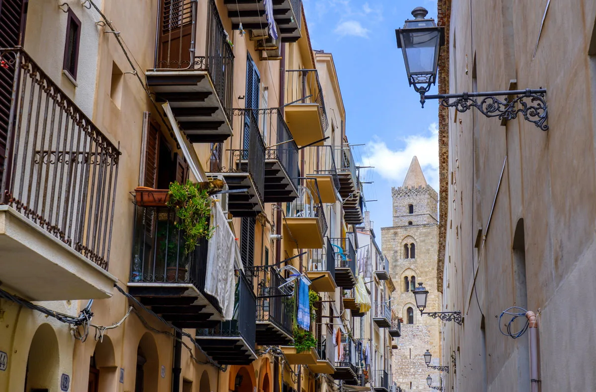 Narrow streets and small balconies surround you in Cefalu, Sicily.