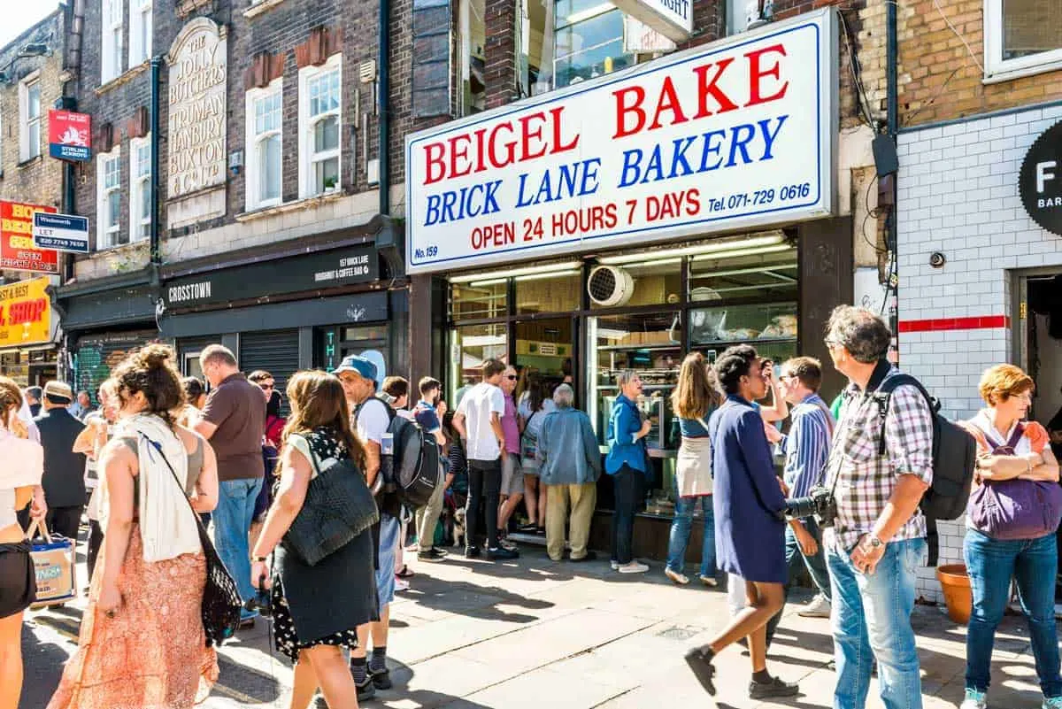 People on the street outside the famous Brick Lane Bakery in London. 