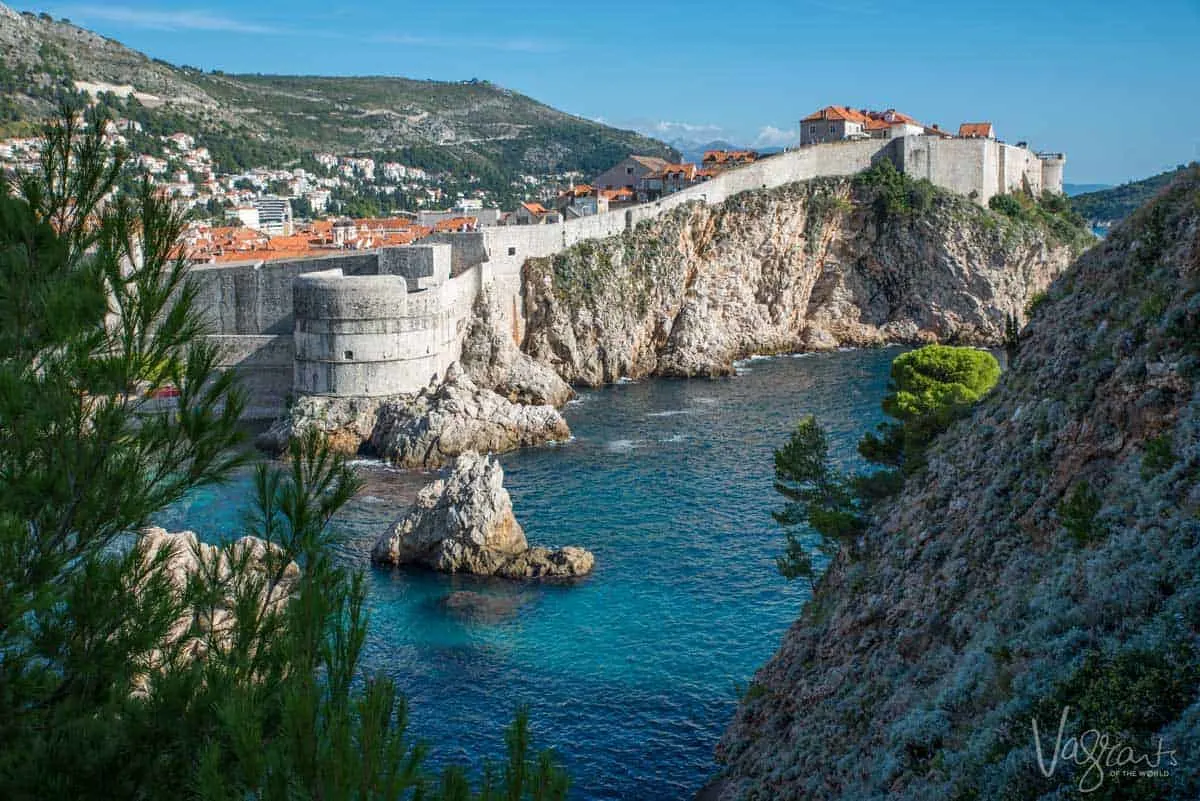 The walled city of Dubrovnik with the blue adriatic sea in the foreground.