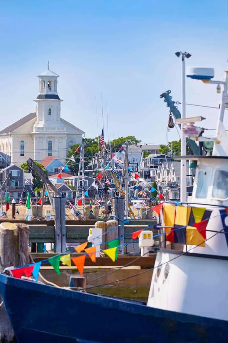 Fishing boats with bright flags in the harbor of Princetown. 