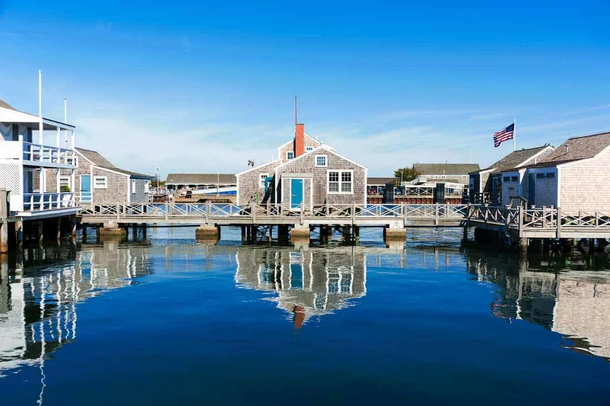 Harbor House reflected in the water in quiet and calm morning in Nantucket Island