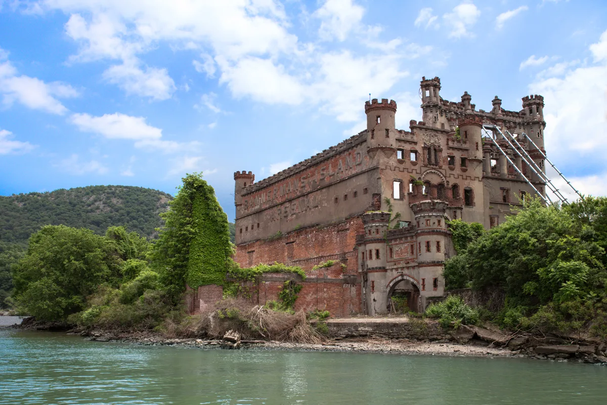 Abandoned Bannerman Castle building surrounded by water and trees on Bannerman's island in Beacon New York. 