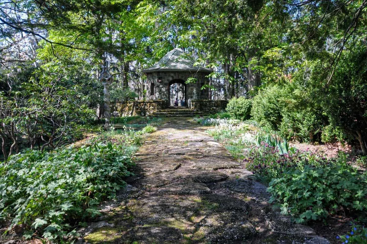 Stone buildings set amongst lush green gardens.