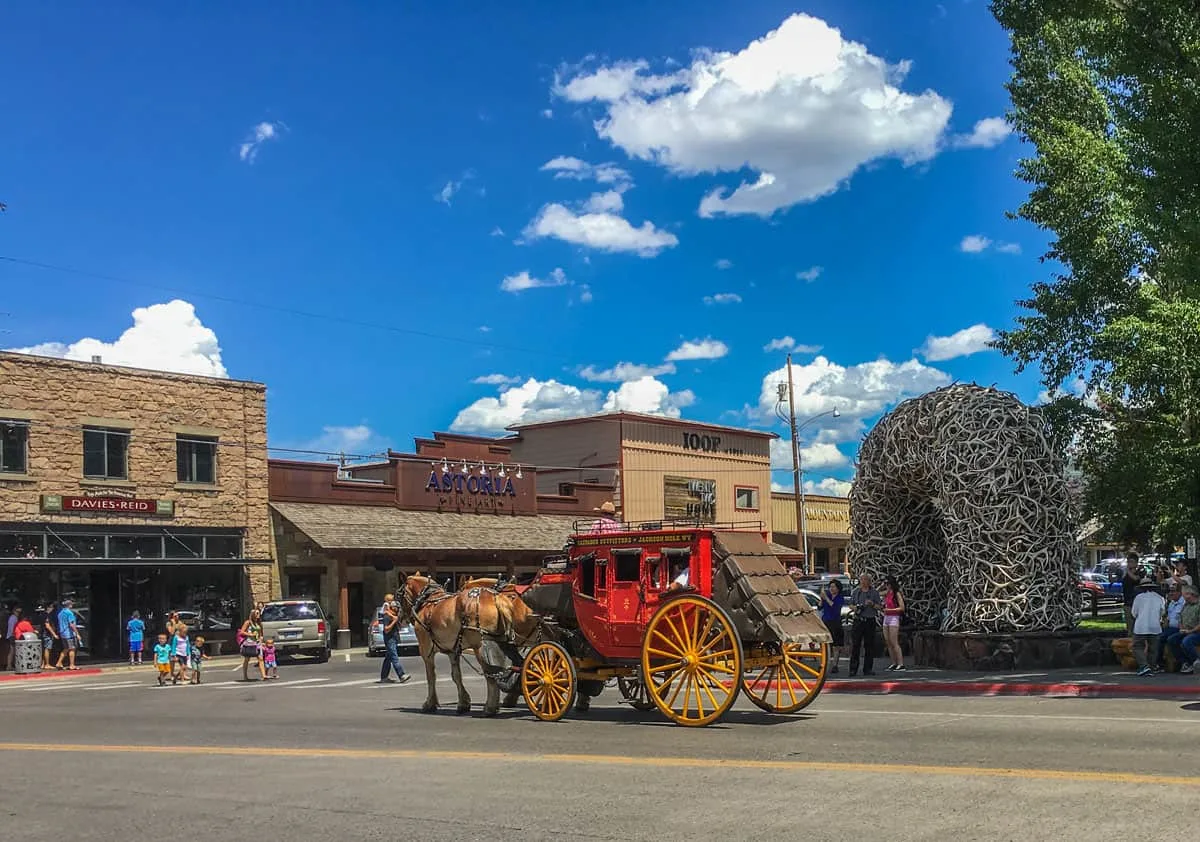 Western style horse drawn wagon travelling through downtown Jackson.