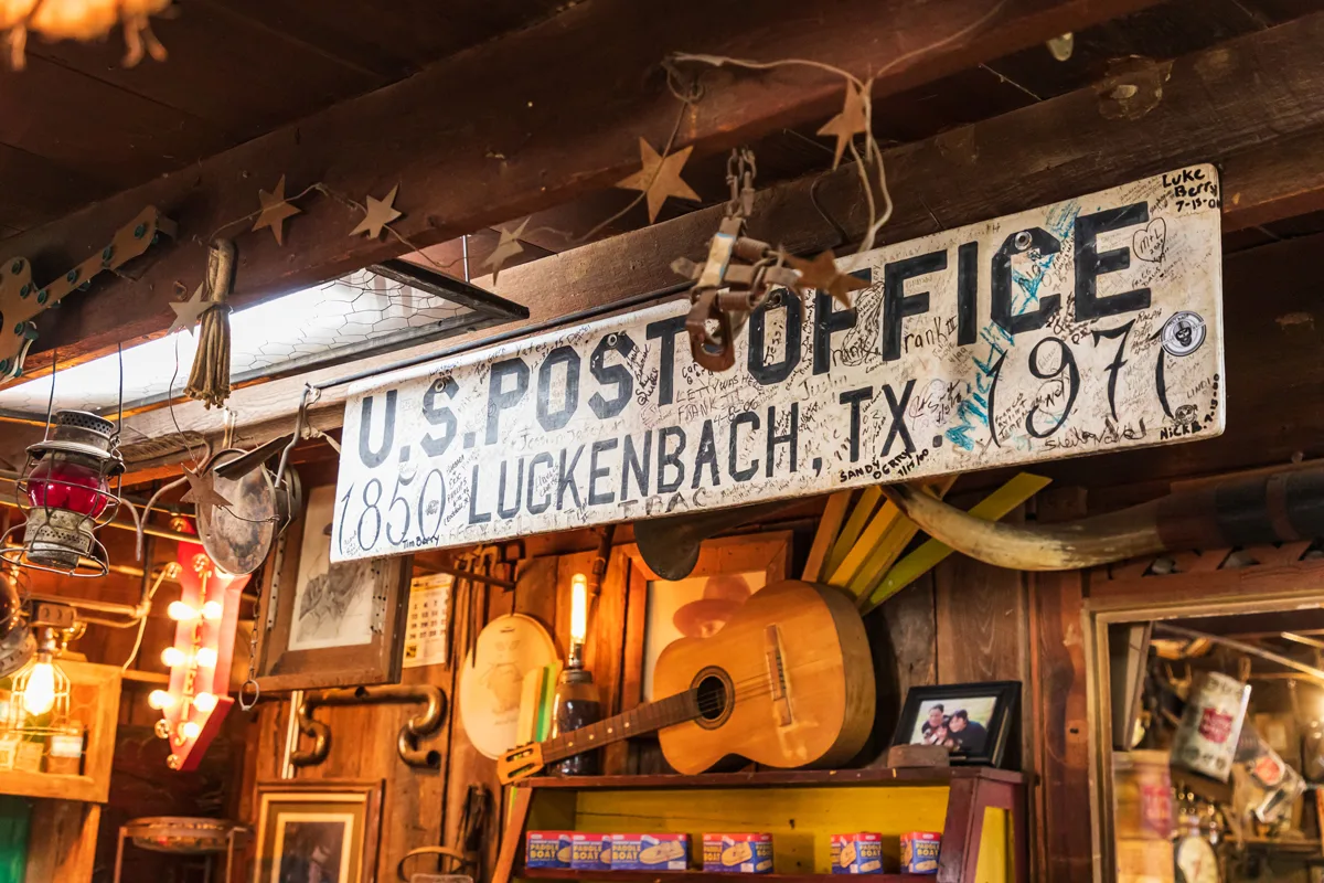 Post office sign and old western memorabilia in a tourist shop in Luckenbach, Texas.