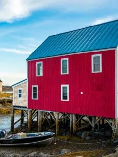 Brigh red fishing shacks over the water in Maine.