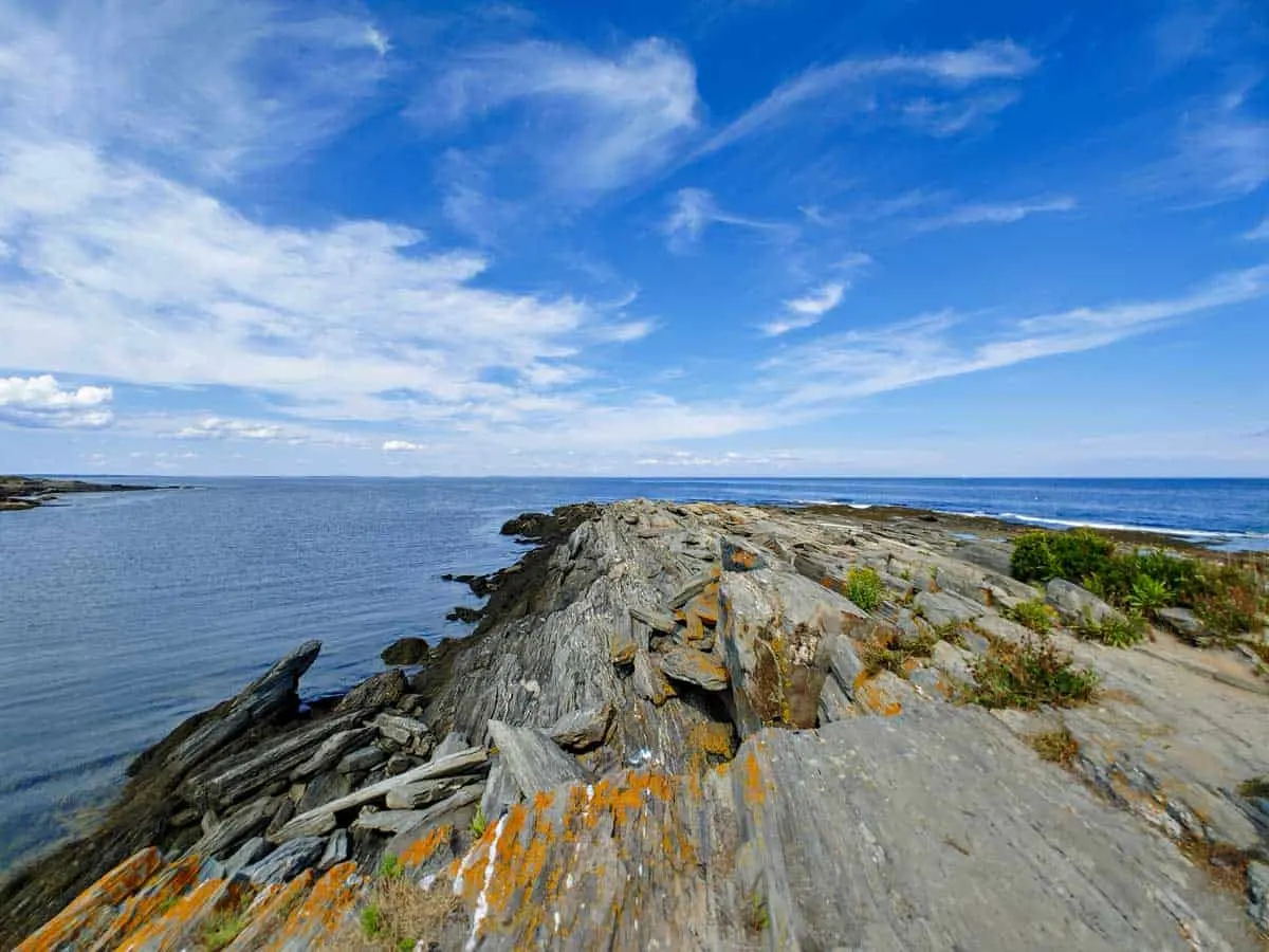 Views out to sea from the Maine Coastline with blue skies.