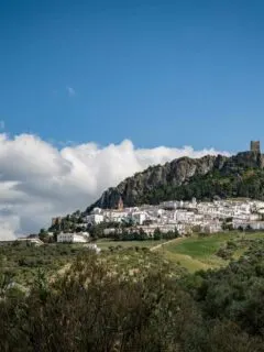 White village in Spain with a castle at the top.