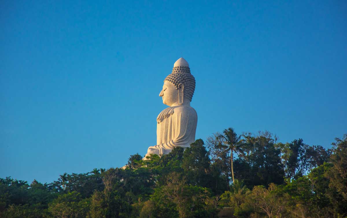 The big Buddah in Phuket Thalaind standing tall above the tree line. 