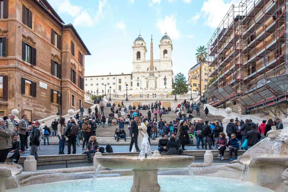 Tourists and a bridal couple in fromnt of the Spanish Steps in Rome. 