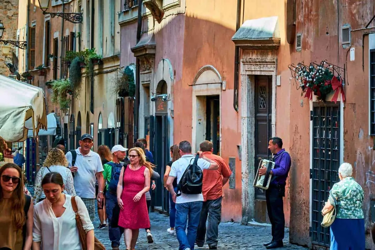 Tourists walking through Trastevere Neighborhood in Rome.