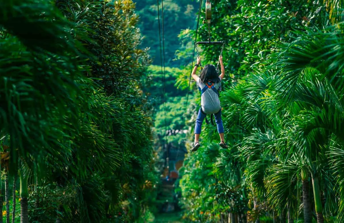 Young girl on a zipline in the Thai forrest. 