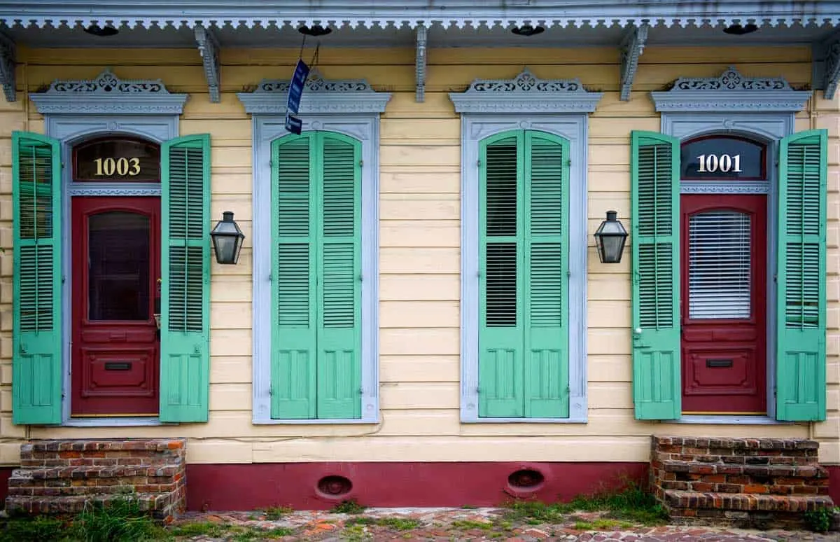 Typical New Orleans houses with green painted French doors.