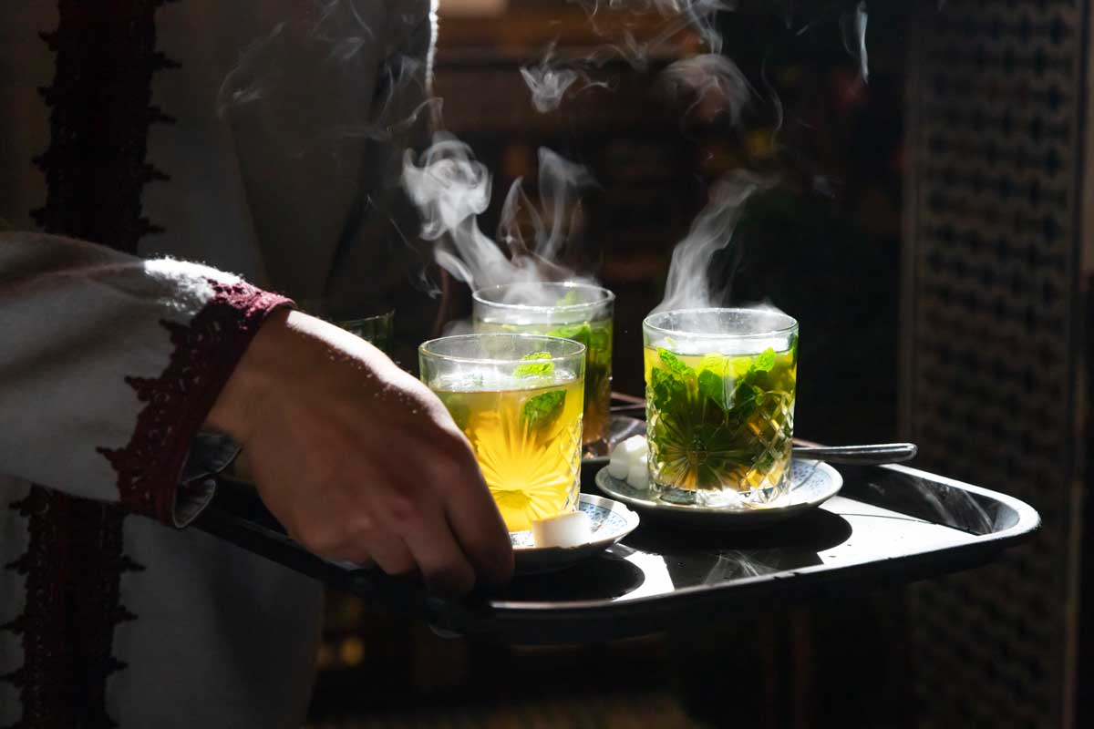 Glasses of steaming hot traditional Moroccan mint tea.