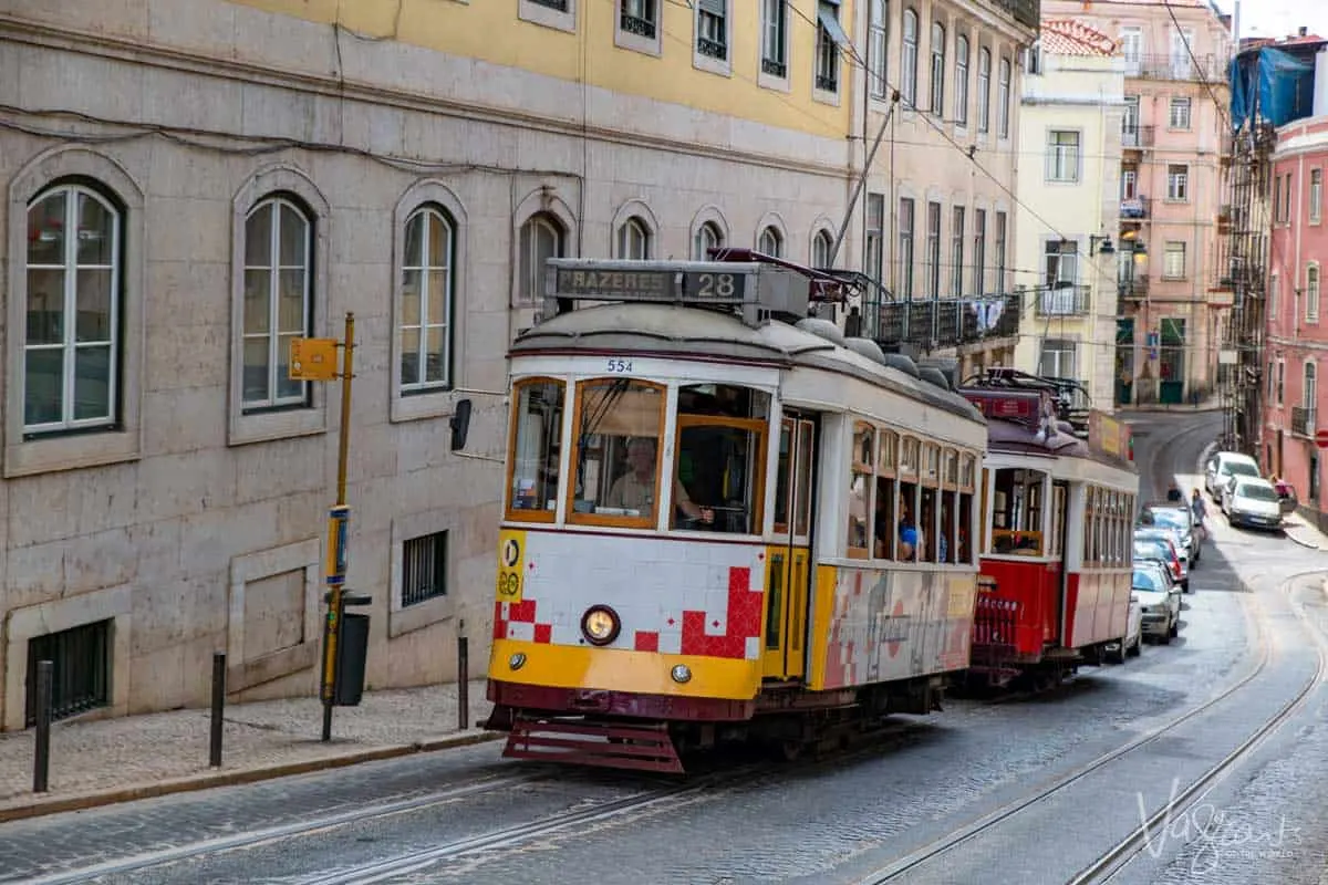 Iconic Lisbon trams climb the narrow city streets. 