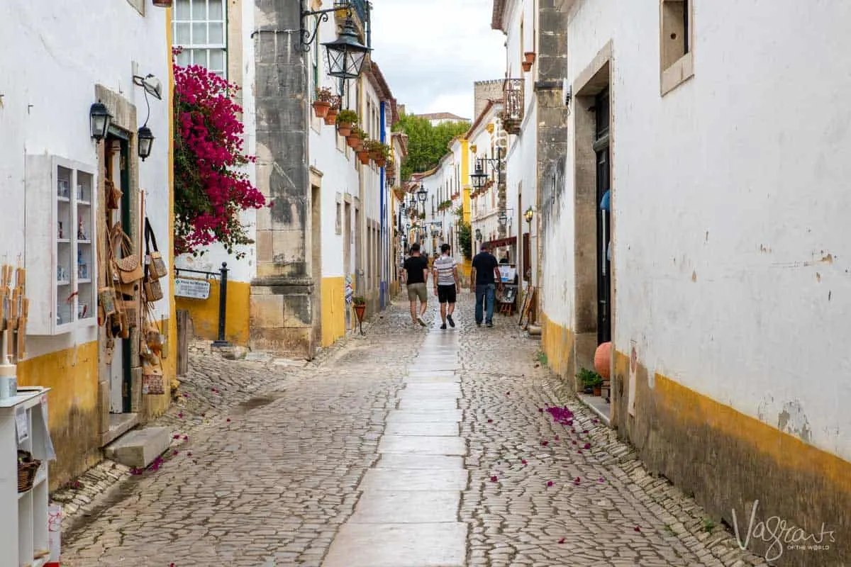 The pretty white washed cobbled streets of Óbidos in Portugal. 