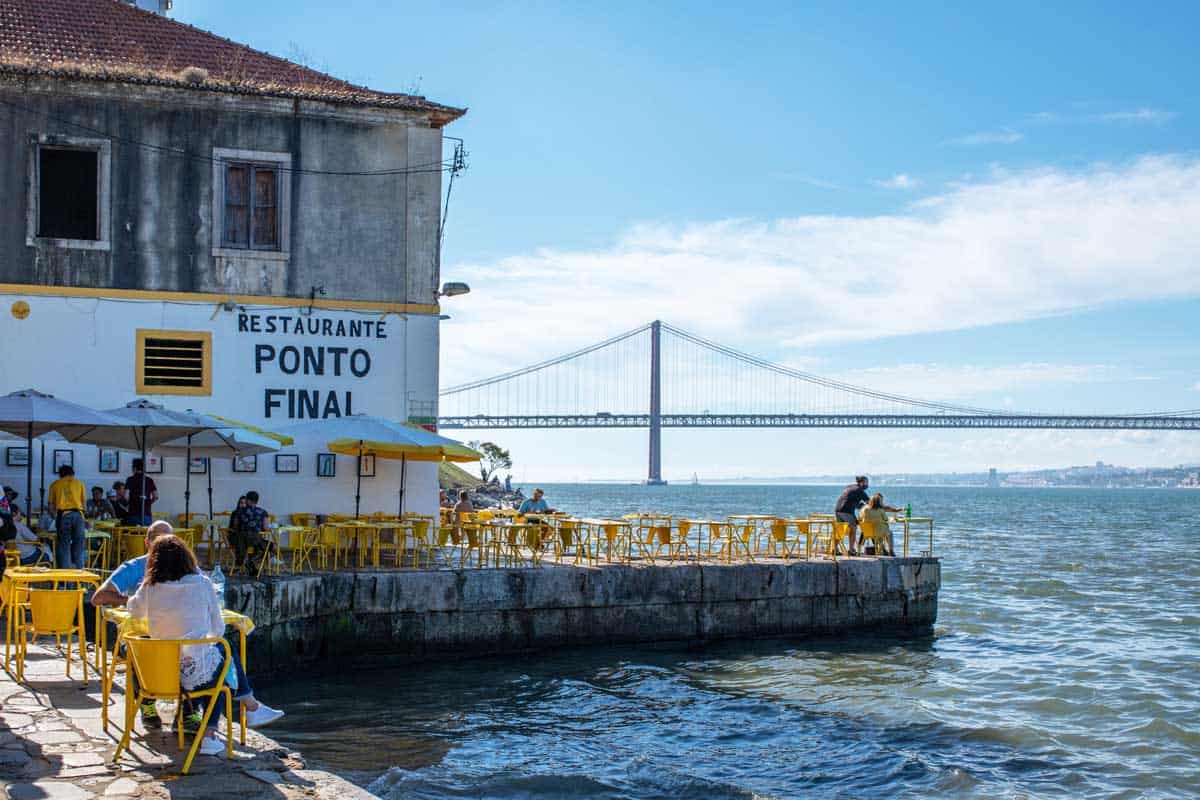Yellow table settings on the waterfront at the Ponto Final Restaurant in Almada.