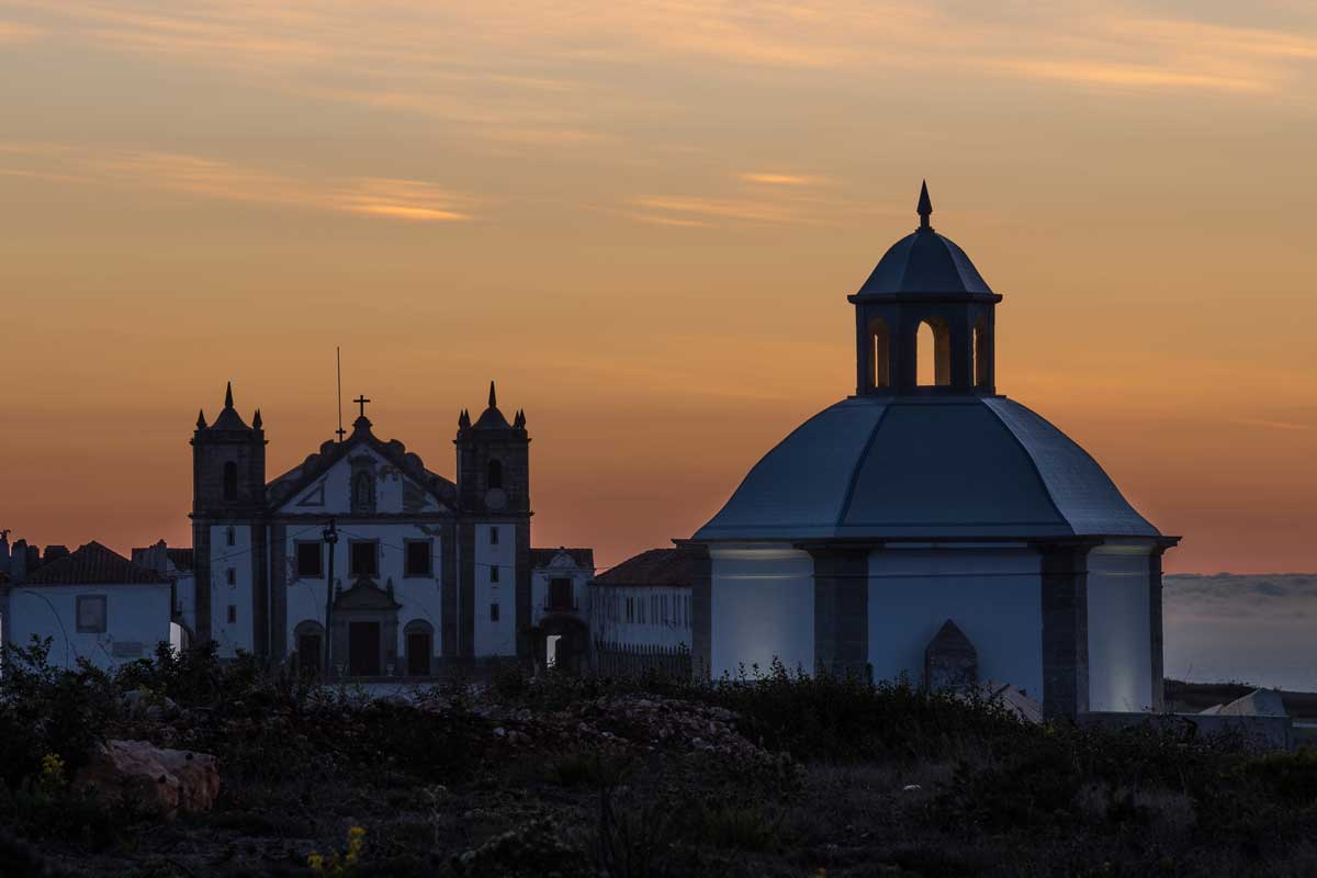 Sunset over the church domes in Sesimbra Portugal. 