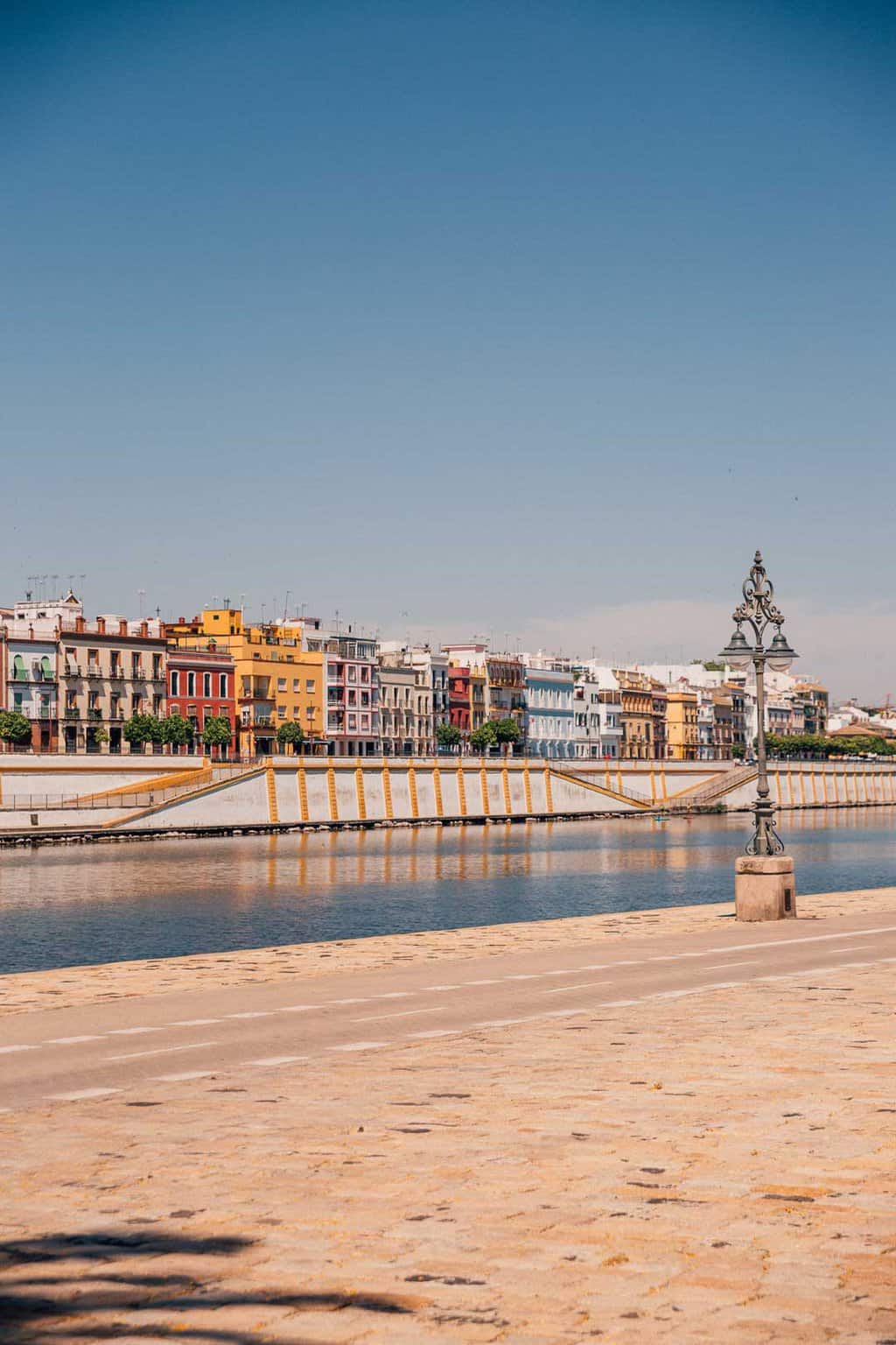 View of the colourful neighbourhood of Triana over the river in Seville. 