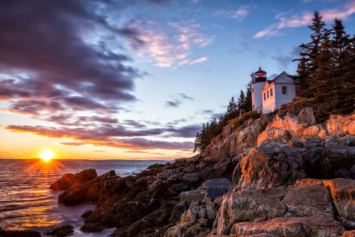 Bass Harbour Lighthouse on cliffs at sunset in Acadia national Park 