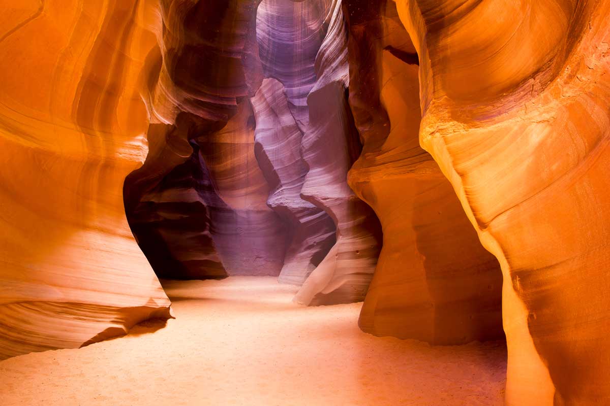 Light coming through the slot of Antelope Canyon Lighting up the red walls. 