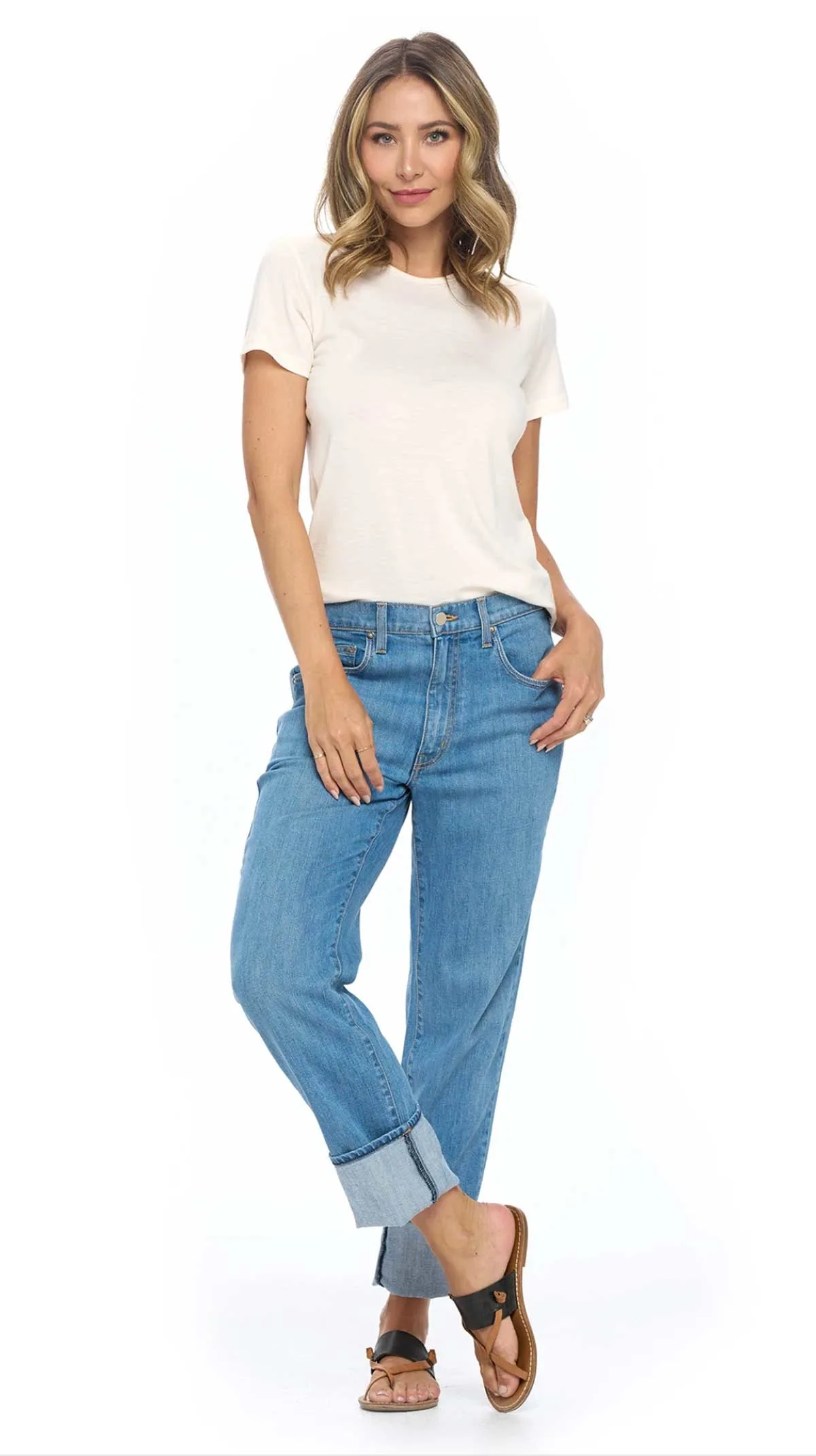 Young atttractive woman modelling a pair of travel jeans in a white T shirt and sandals. 