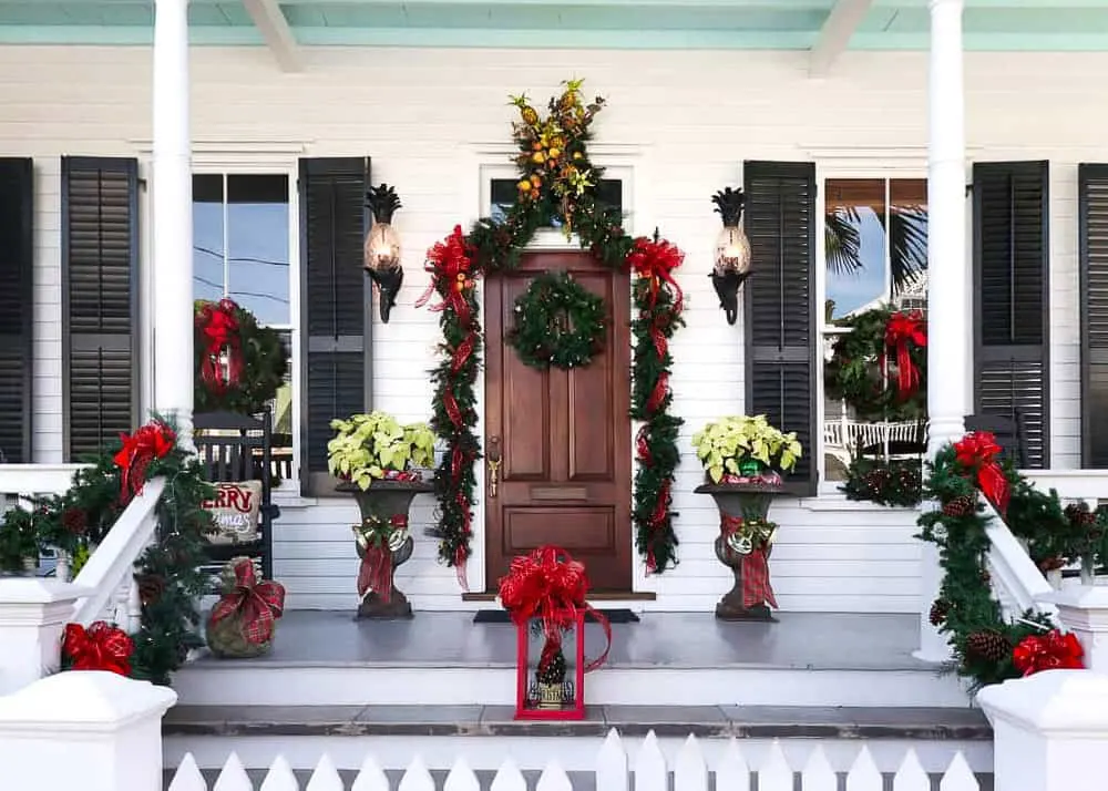 The porch of a white timber house in Key West decorated with lavish Christmas decorations.