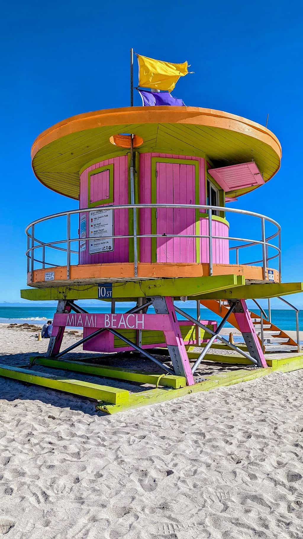 Life guard tower on Miami beach painted bright pink and yellow. 