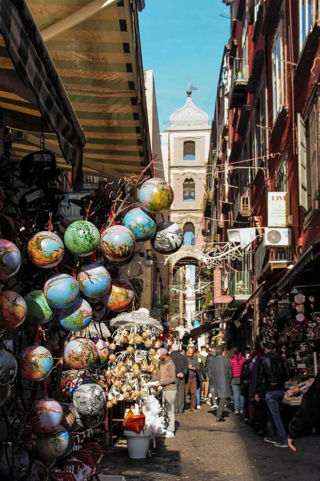 A narrow lane way in Naples lined with souvenir stalls. 