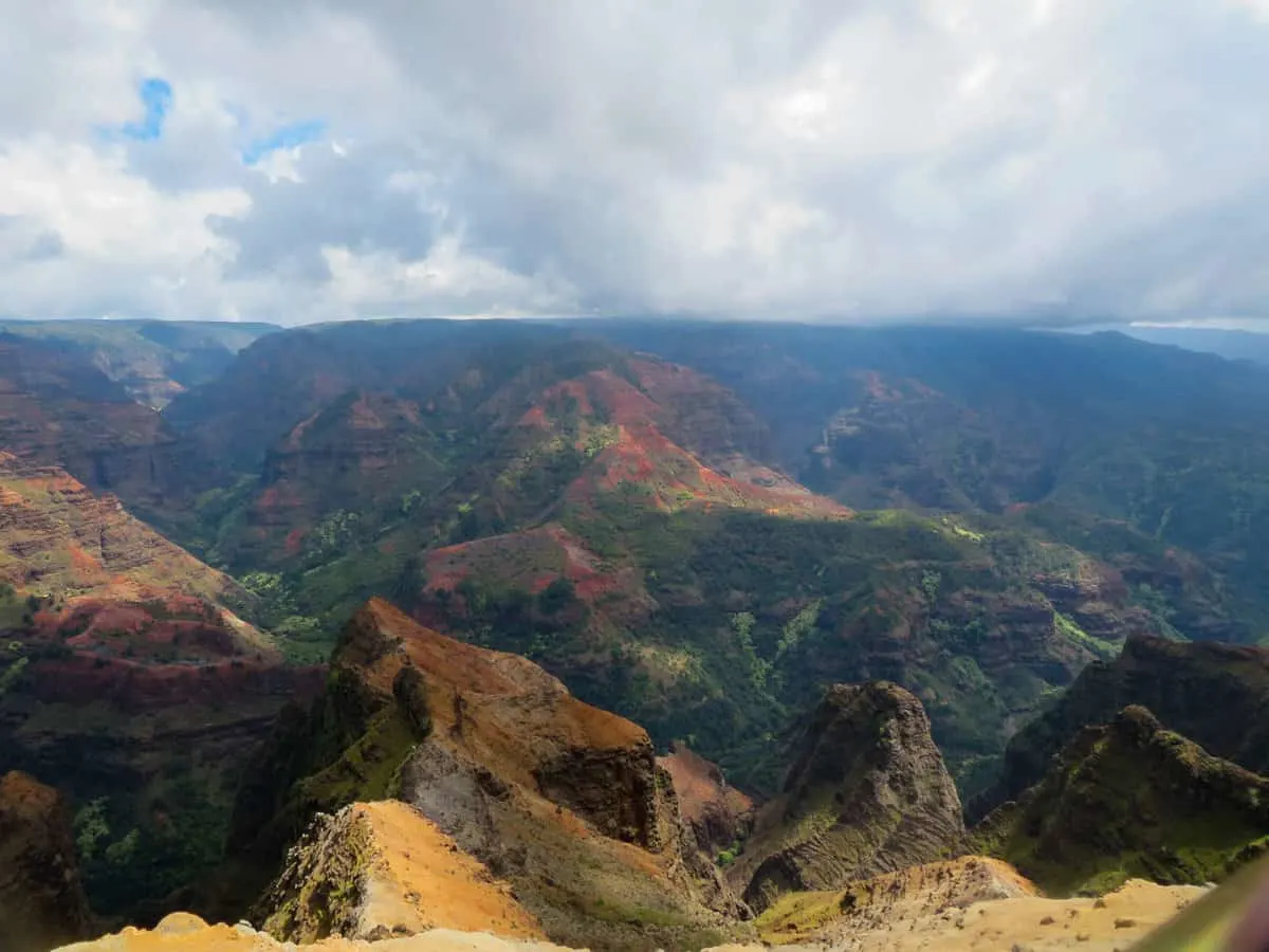 A cloudy day overlooking a lush canyon landscape on Kauai Island Hawaii. 