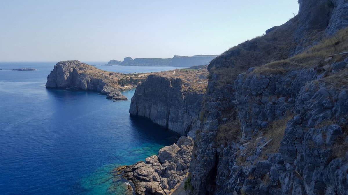 Views from the top of cliffs over clear blue water on Rhodes island Greece. 