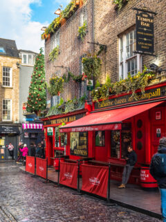 people standing in the cobble streets of the famous temple Bar district in Dublin.