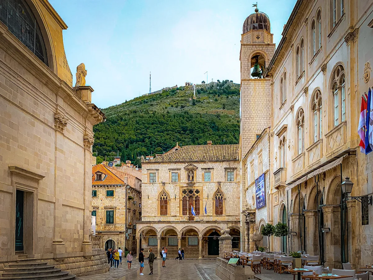 Tourists standing in the empty streets of Old Town Dubrovnik on a rainy day. 