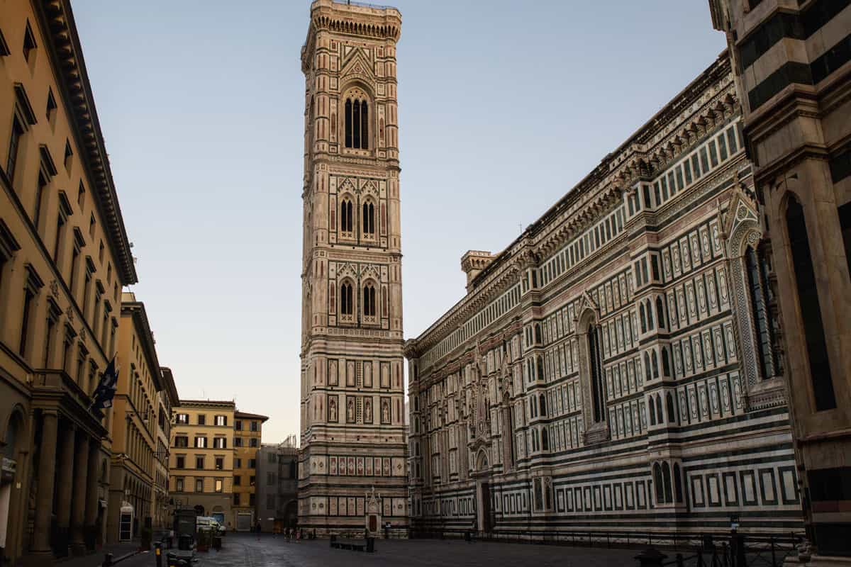 The free standing Giotto's bell tower with the mosaic marble exterior in Florence. It is early morning and no one is around. 