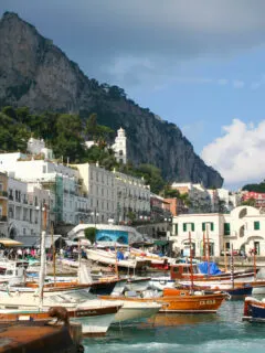 Colourful wooden boats in a traditional Italian island harbour on Capri Island.