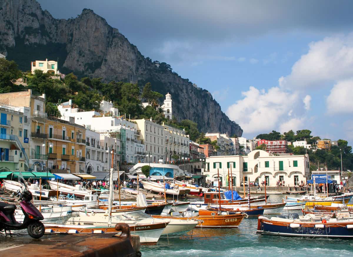Colourful wooden boats in a traditional Italian island harbour on Capri Island.