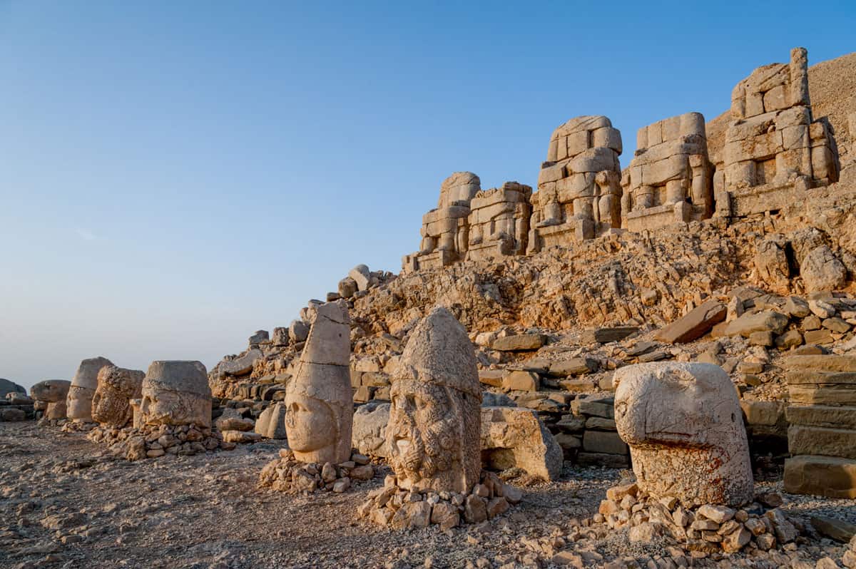The heads from ancient staues sit detached from their bodies in a rubble landscape in Mount Nemrut in Turkey.