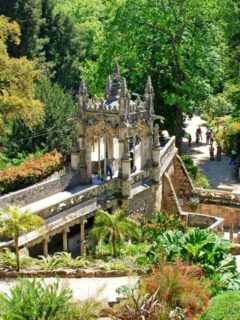 Tourists in the lush green historical Majestic Garden in Sintra Portugal on a sunny day.