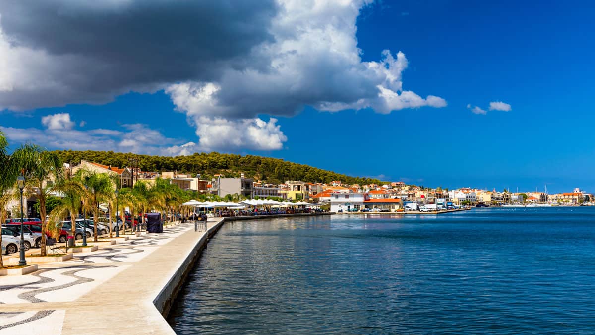 A boardwalk traces the blue harbour to the colourful buildings in the town of Argostoli in Kefalonia.