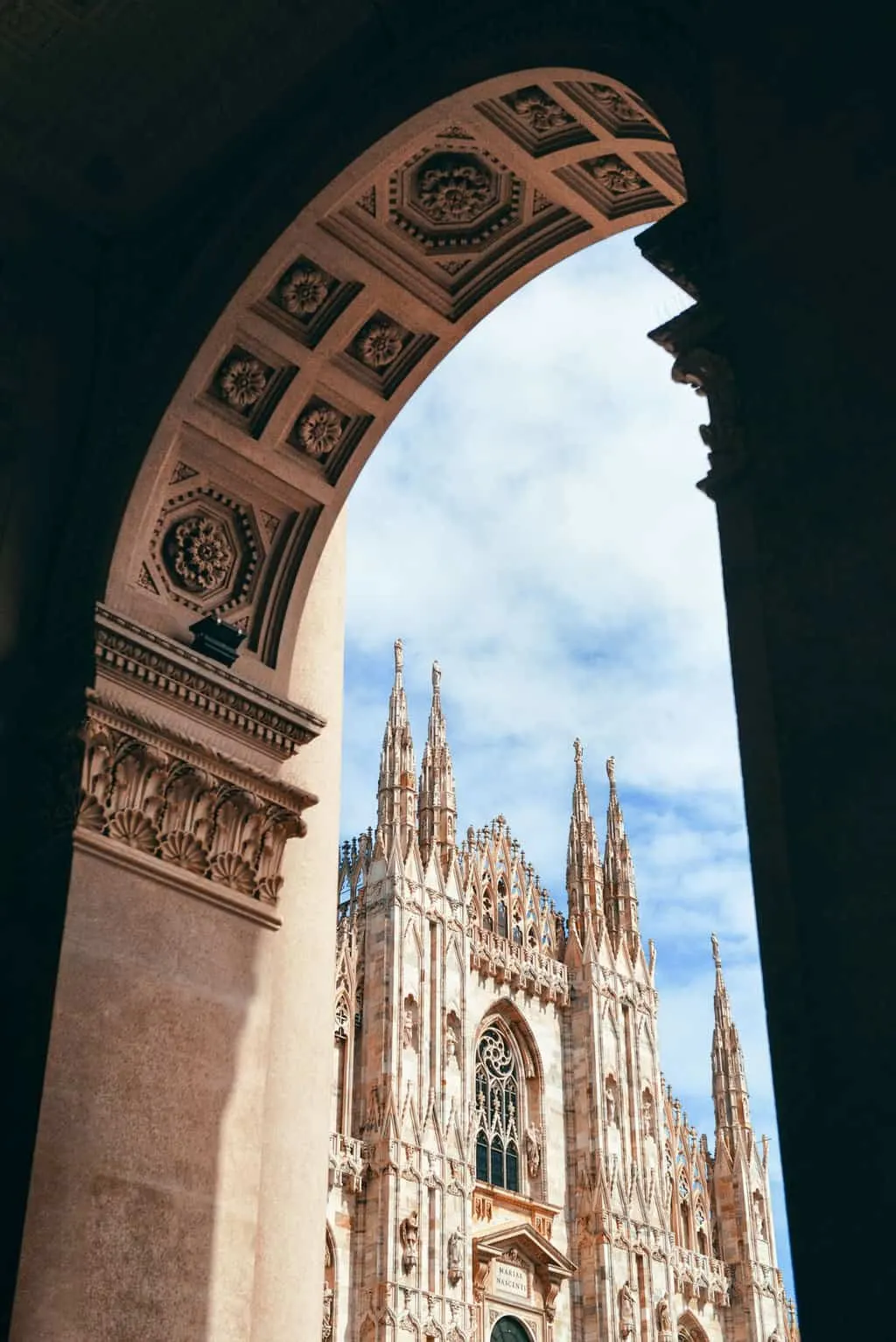 Milan Cathedral viewed through archway in Italy.