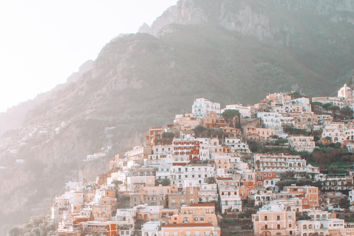 Colourful buildings cascade down a hill on a hazy day in Positano Italy. 