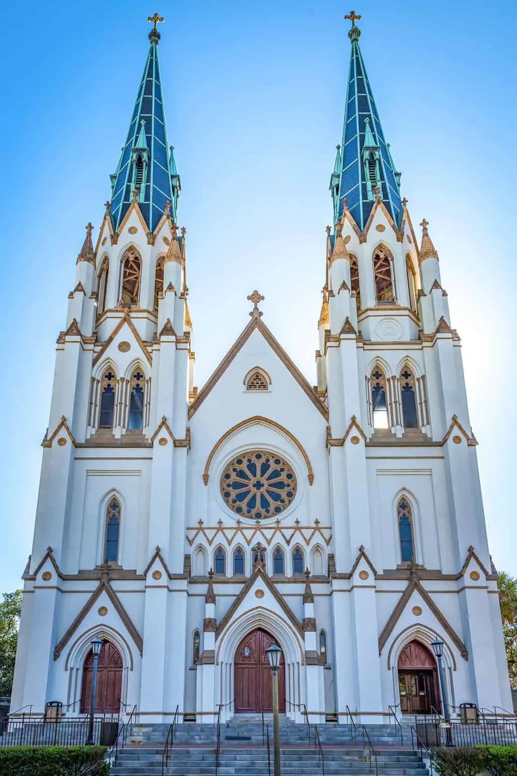 The white, blue and gold exterior of a cathedral with twin spires.