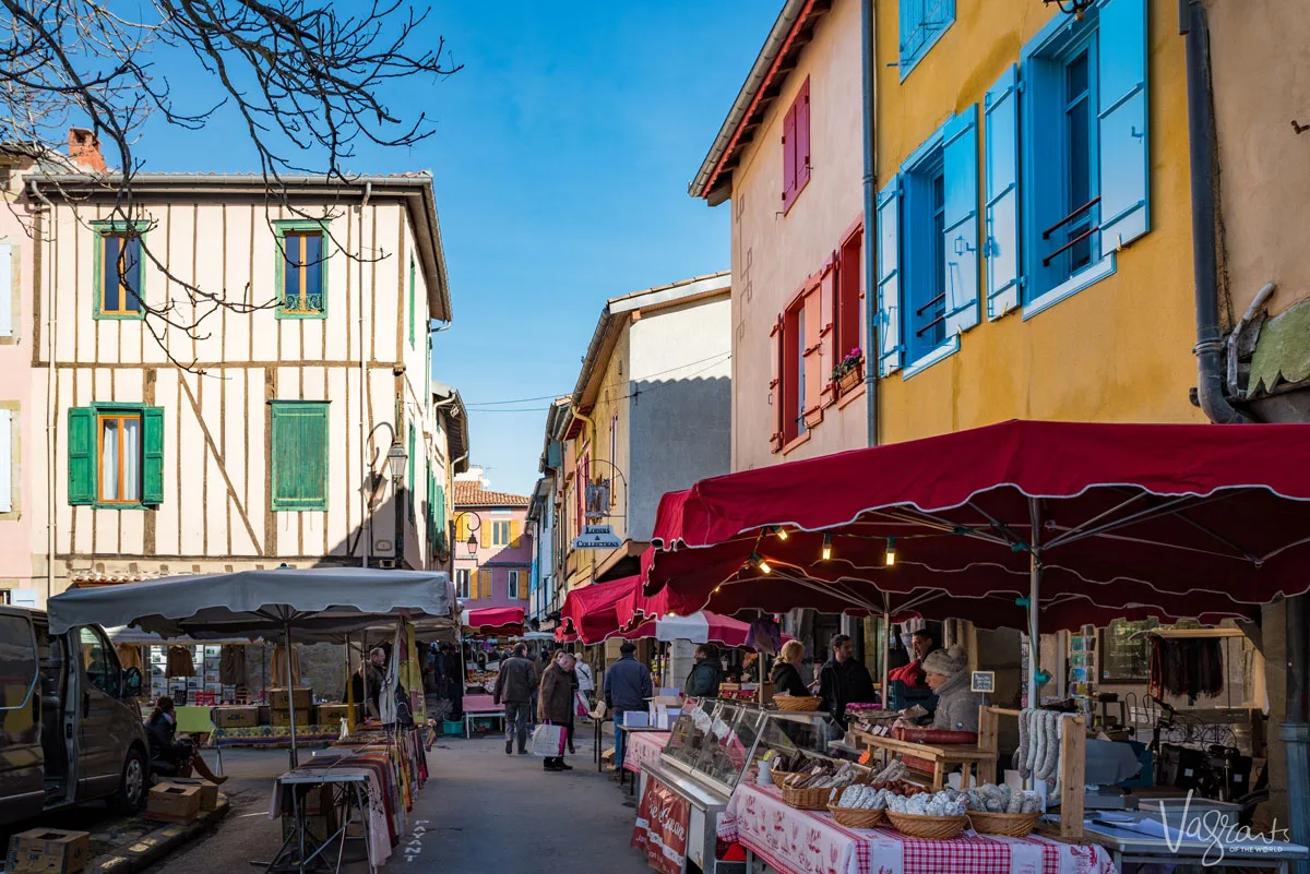A colourful medieval village with a street market in Mirepoix France. 
