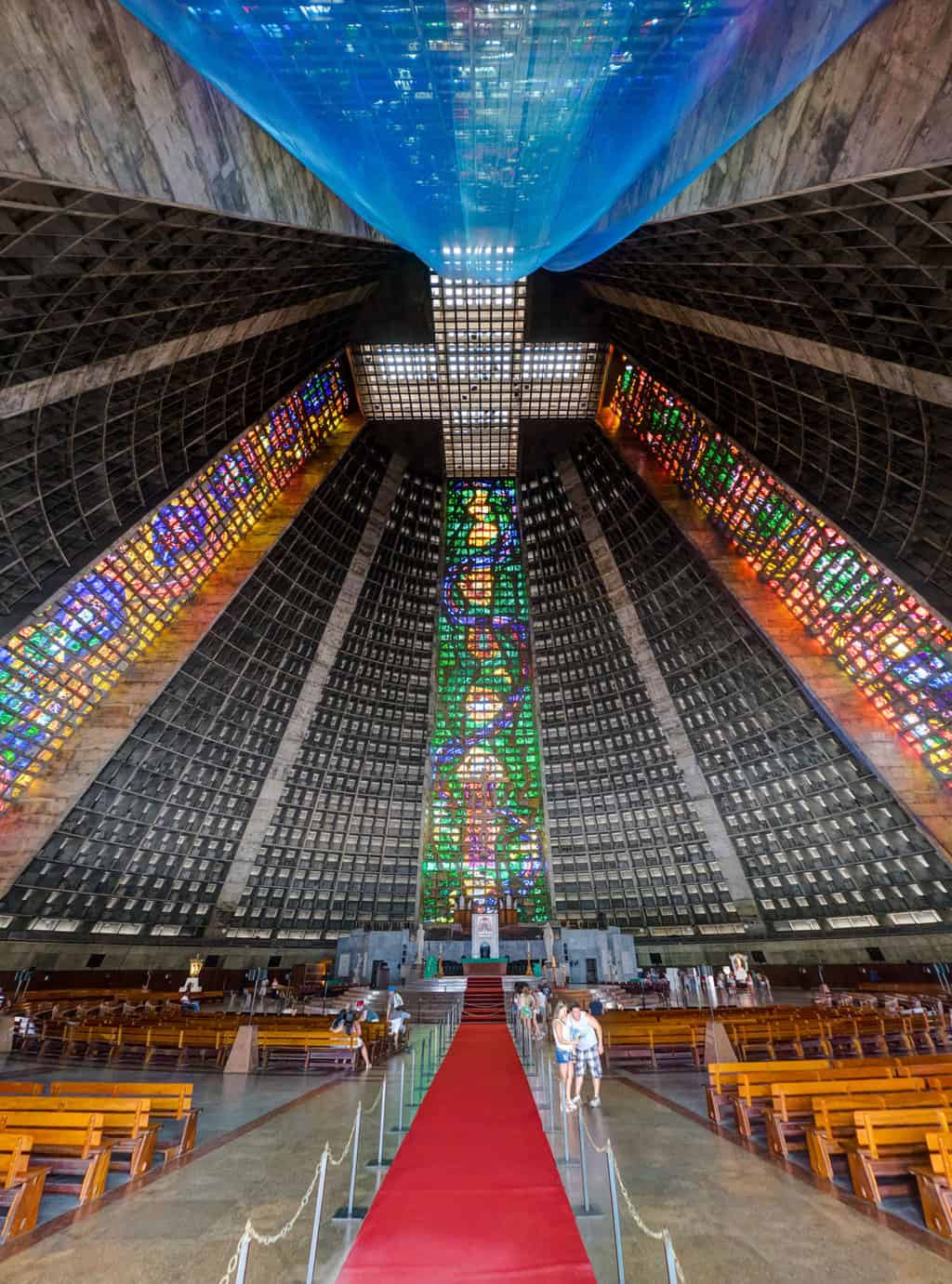 Stain glass windows reaching up the length of the Pyramid Mayan style cathedral.