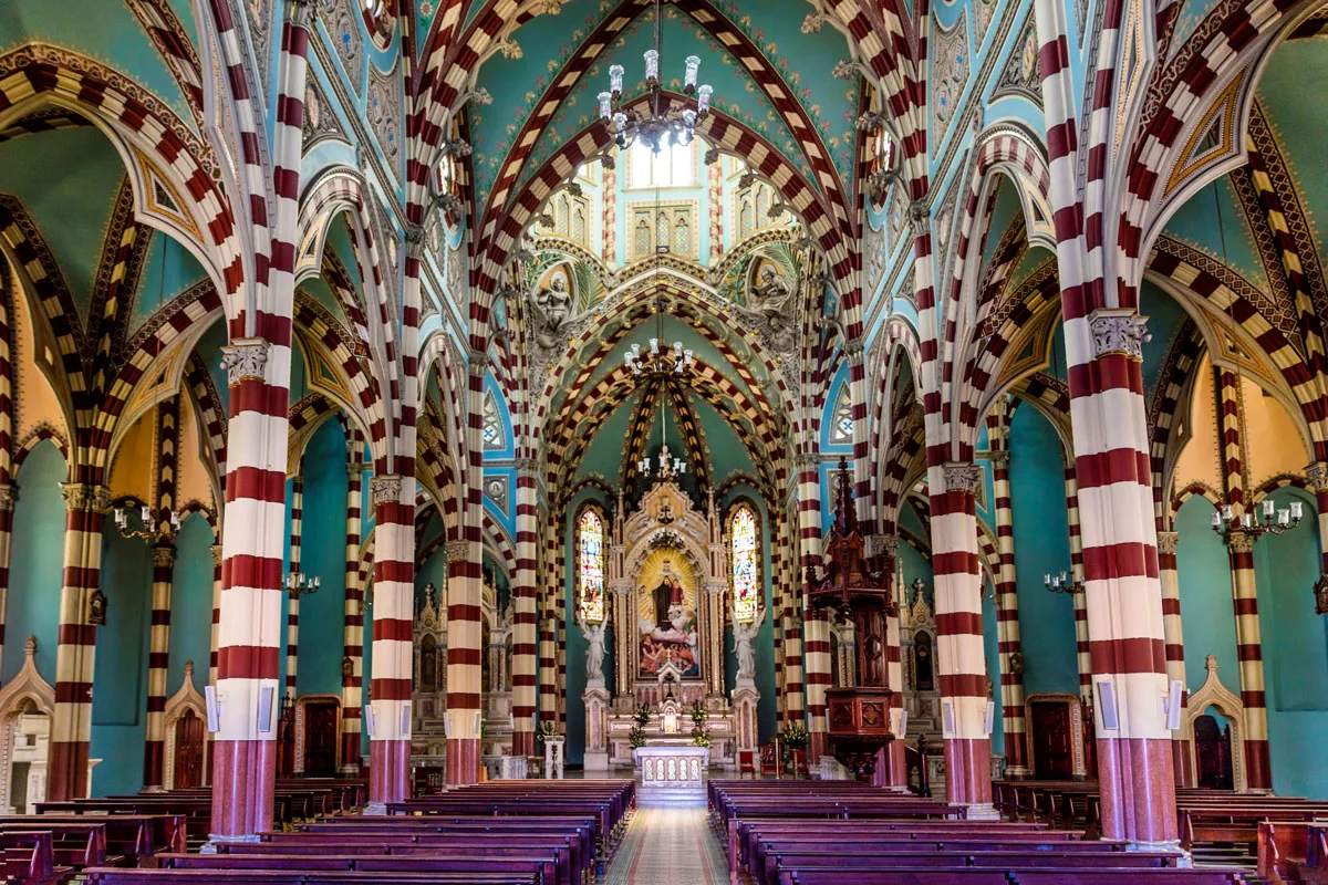 The colourful green, red and white interior of a church.