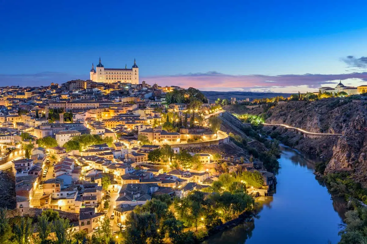 City of Toledo at night with the lights shining throughout the town.