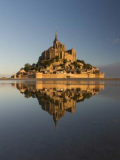 The Abbey of Mont Saint Michel reflecting in the water.