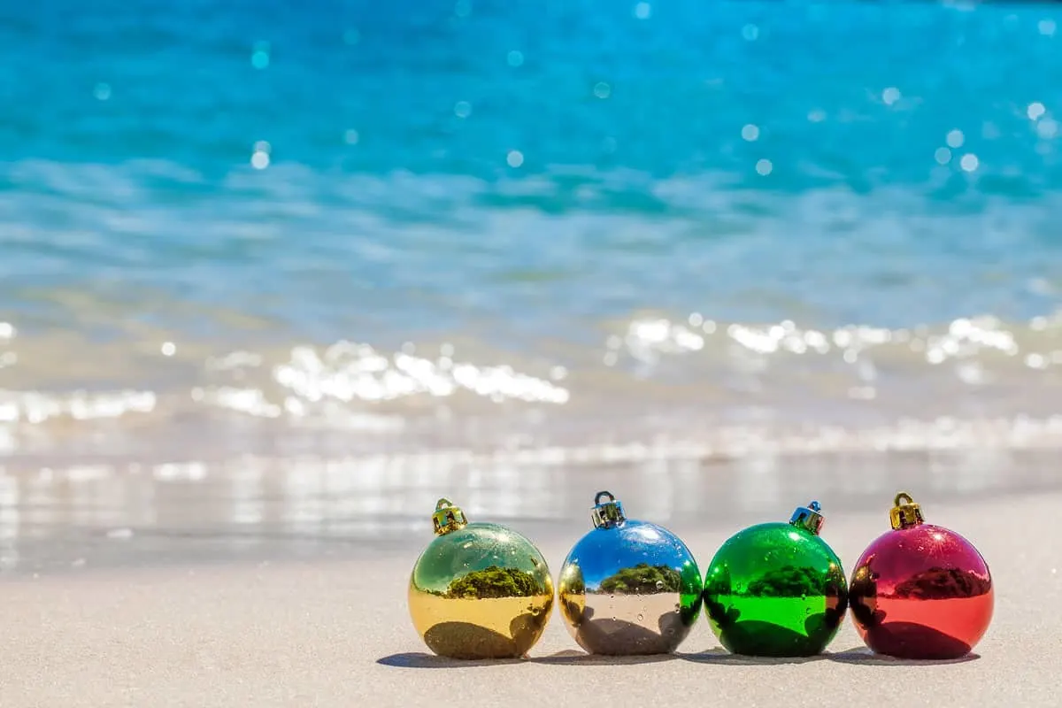 Coloured Christmas balls on a white sand beach in Thailand. 