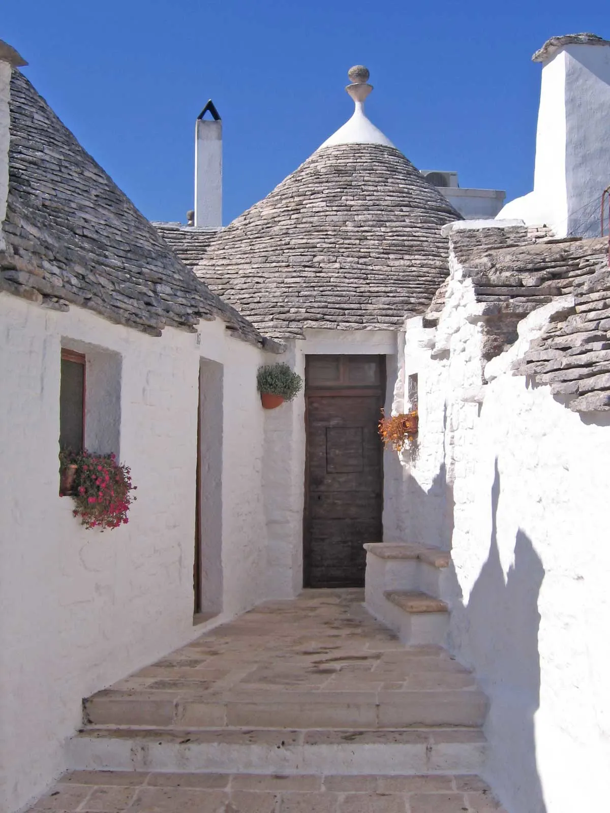 A typical white house in Puglia Italy with the cone shaped slate roof.